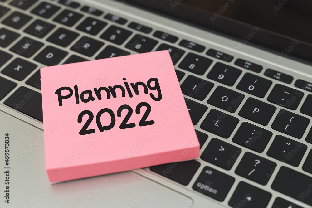 Sticky post notepaper with text planning 2022 on laptop keyboard. Sticky post notepaper with text planning 2022 on laptop keyboard.