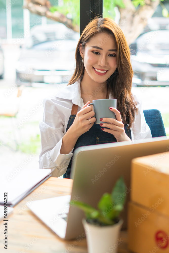 Portrait of asian young woman using laptop at cafe, she is working on laptop computer at a coffee shop. Portrait of asian young woman using laptop at cafe, she is working on laptop computer at a coffee shop.