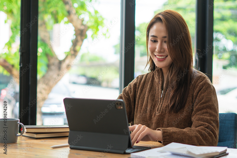 Portrait of asian young woman using laptop at cafe, she is working on laptop computer at a coffee shop. Portrait of asian young woman using laptop at cafe, she is working on laptop computer at a coffee shop.