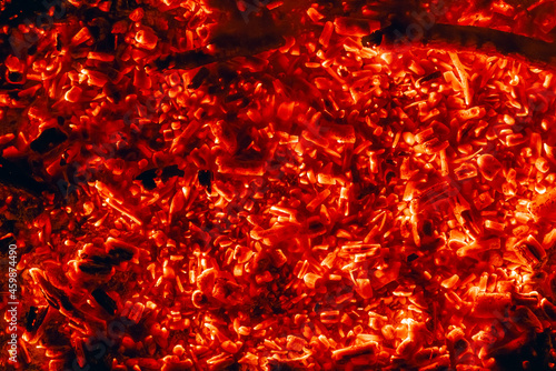 Smoldering charcoal in a bonfire, background texture