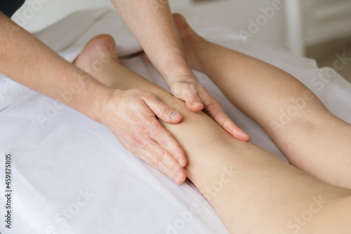 masseur massages a girl's feet 
