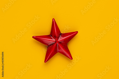 Christmas star decor on yellow colored background. © gitusik