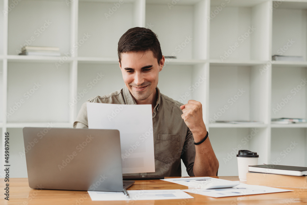 caucasian business man working with documents and laptop. caucasian business man working with documents and laptop.