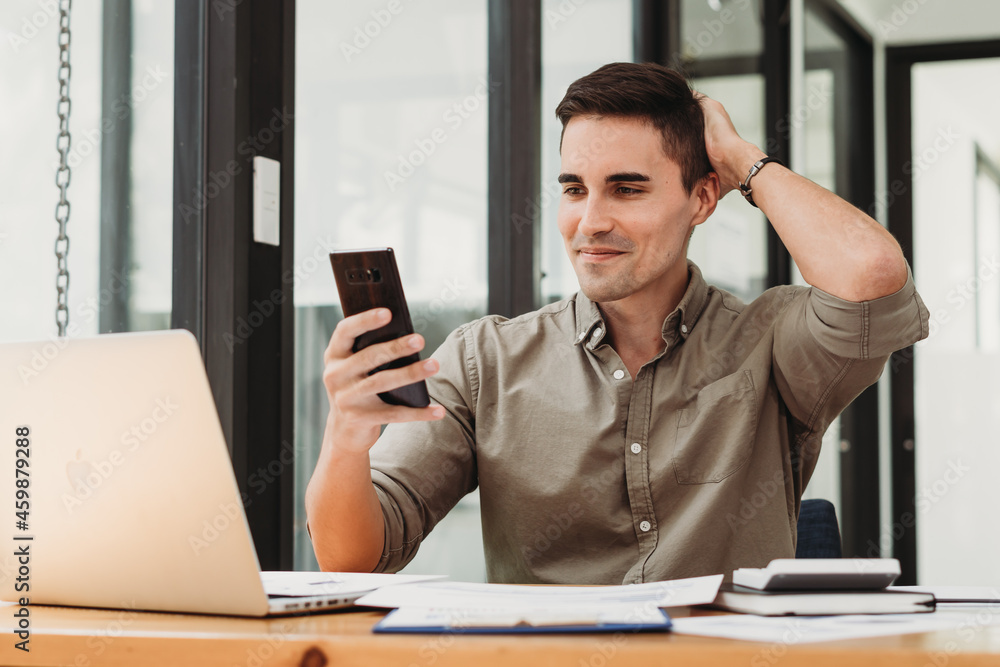 Businessman in shirt working on his laptop in an office. Open space office Businessman in shirt working on his laptop in an office. Open space office