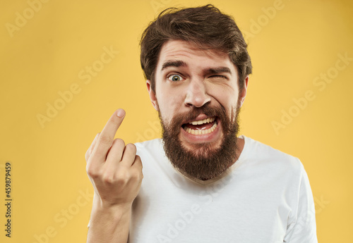 bearded man in a white t-shirt hand gestures anger Studio