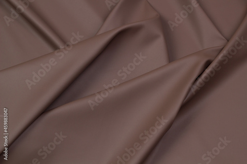 Leather red top view, folds. Brown textile skin 