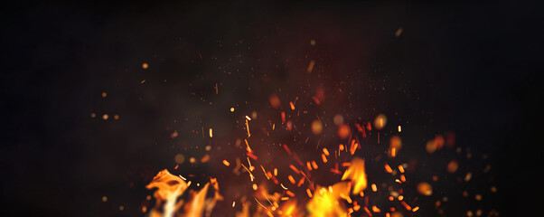 Halloween Witch .  Fire embers particles over black background. Fire sparks background. Abstract dark glitter fire particles lights.