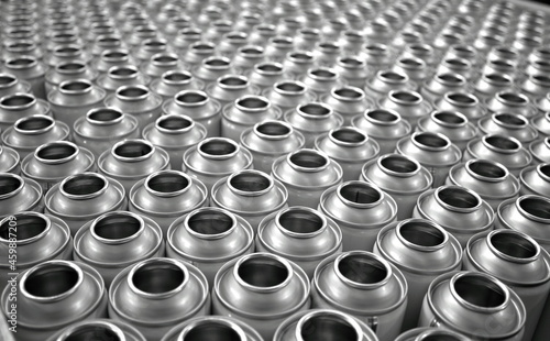 Top view of empty aerosol cans in busy manufacturing factory