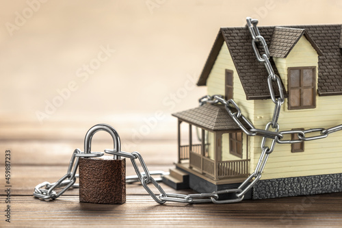 Fototapeta House tied with a chain and a closed lock
