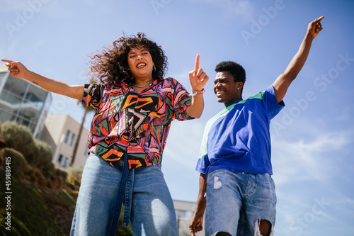 African American boy and girl dancing in the street
