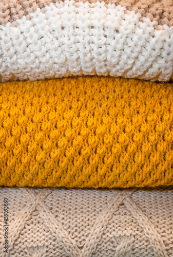 macro texture of three sweaters. fabric fiber yellow, brown and white background