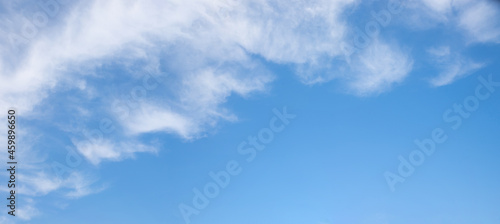 blue sky with fluffy clouds in the diagonally upper half