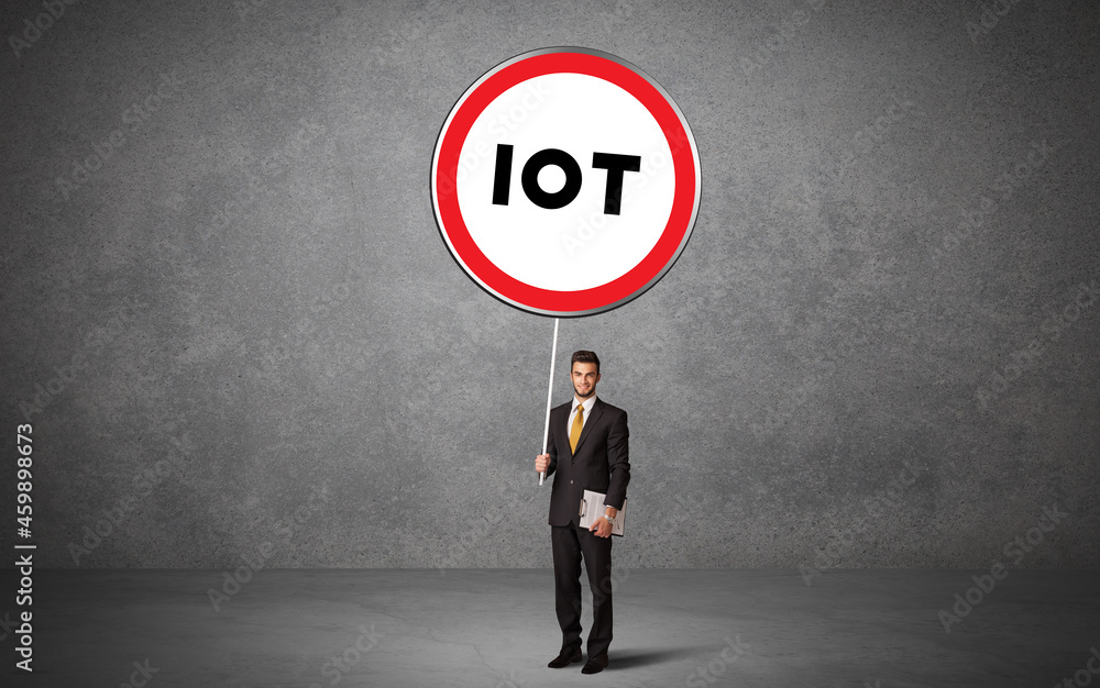 Fototapeta premium Young business person holdig traffic sign