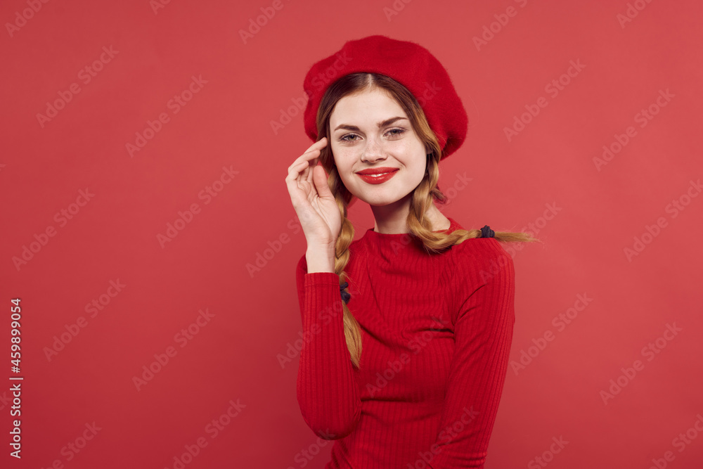 Fototapeta premium beautiful woman with a red cap on his head glamor studio posing