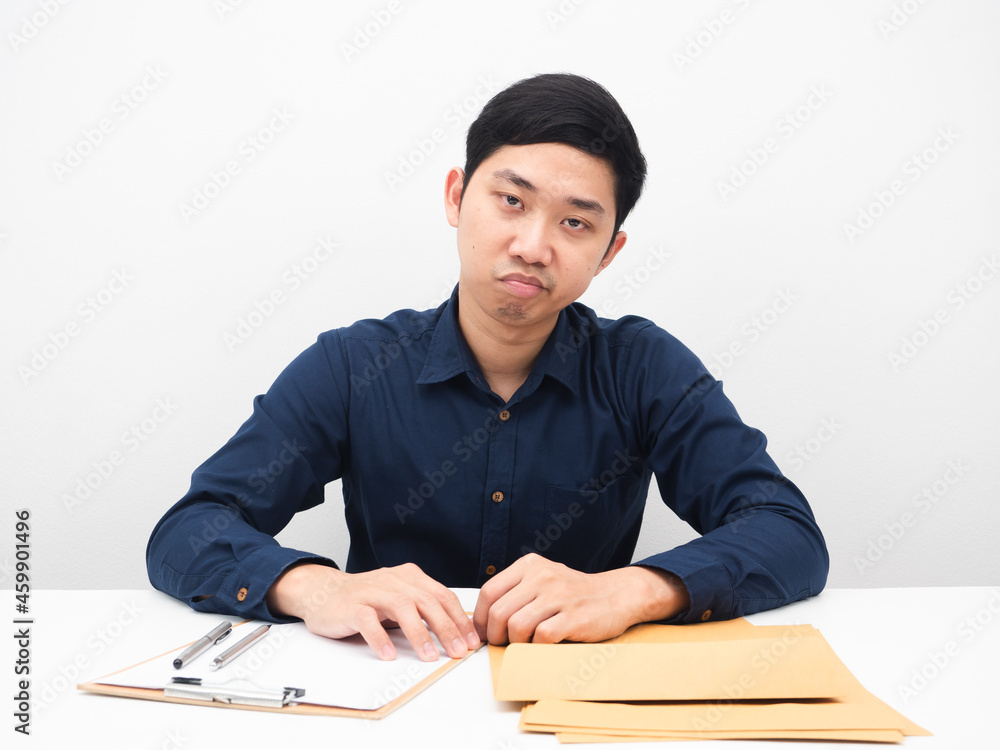 Businessman feeling bored sit at table workplace looking at camera white background Businessman feeling bored sit at table workplace looking at camera white background