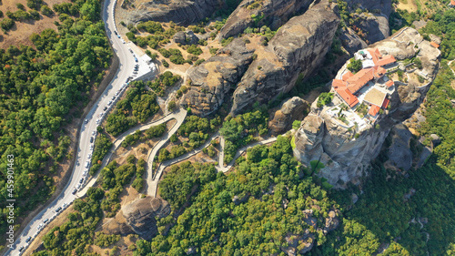Aerial drone photo of iconic Holy Trinity Monastery at Meteora monasteries complex of immense natural pillars and hill-like rounded, an Unesco World Heritage site, Western region of Thessaly, Greece