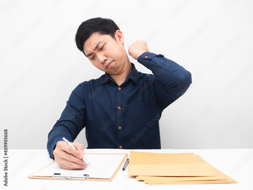 Man writing and working wtih document at the table feeling tried white background Man writing and working wtih document at the table feeling tried white background
