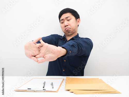 Businessman sitting at his workplace stretch oneself feeling lazy to working