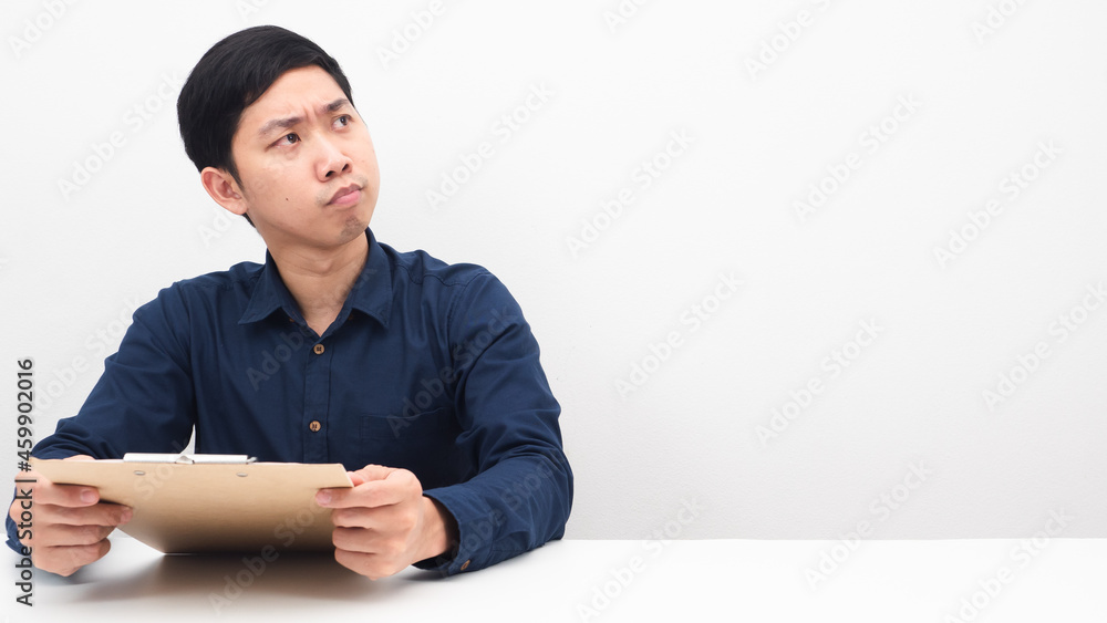 Man serious face holding document board in hand looking at copy space white background Man serious face holding document board in hand looking at copy space white background