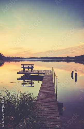 Lake Lipie with wooden pier at sunset  color toning applied  Poland.