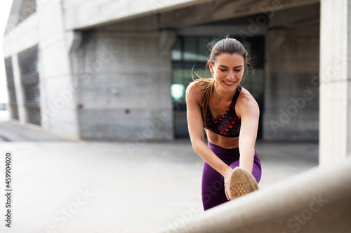 Beautiful athlete woman training outdoors. Young fit woman doing exercise outside..