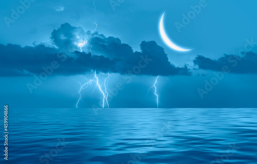Night sky with Blue crescent moon in the clouds on the fore ground calm blue sea 