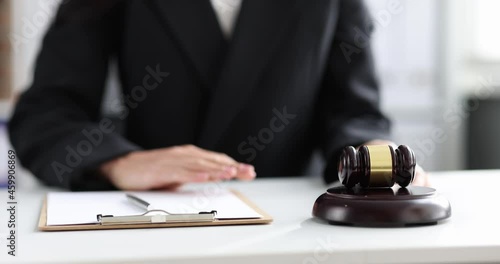 Judge writing in documents on clipboard and knocking with wooden gavel 4k movie