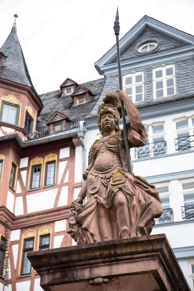 The Minerva Fountain in front of historic half timbered buildings in Romer, Frankfurt, Germany.