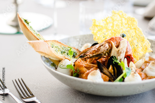 Fish stew with lobster, prawns and seafood foam at a restaurant