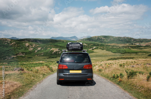 family car with roof box on the top going on an road trip in the UK photo