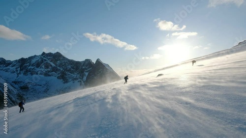 Mountaineer group trekking on slope mountain with blizzard