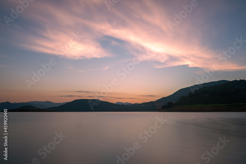 The evening lake reflected the mountains and the sky on both sides;