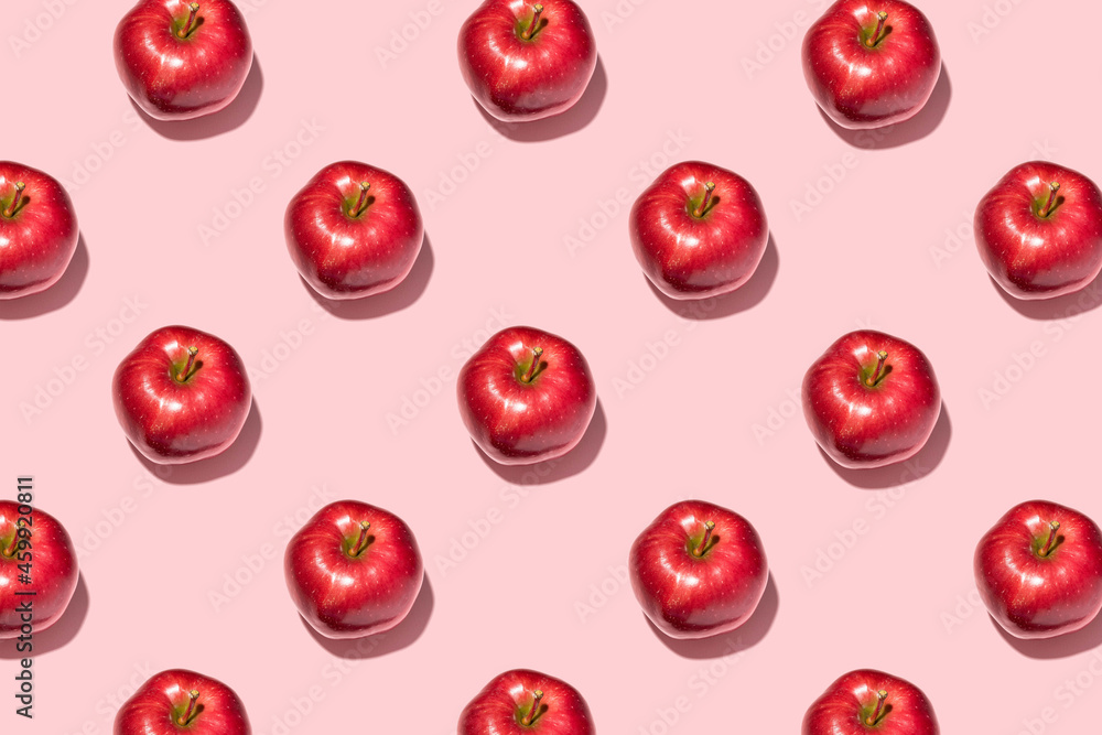 Red apples on pink background. Pattern, top view, flat lay. Red apples on pink background. Pattern, top view, flat lay.