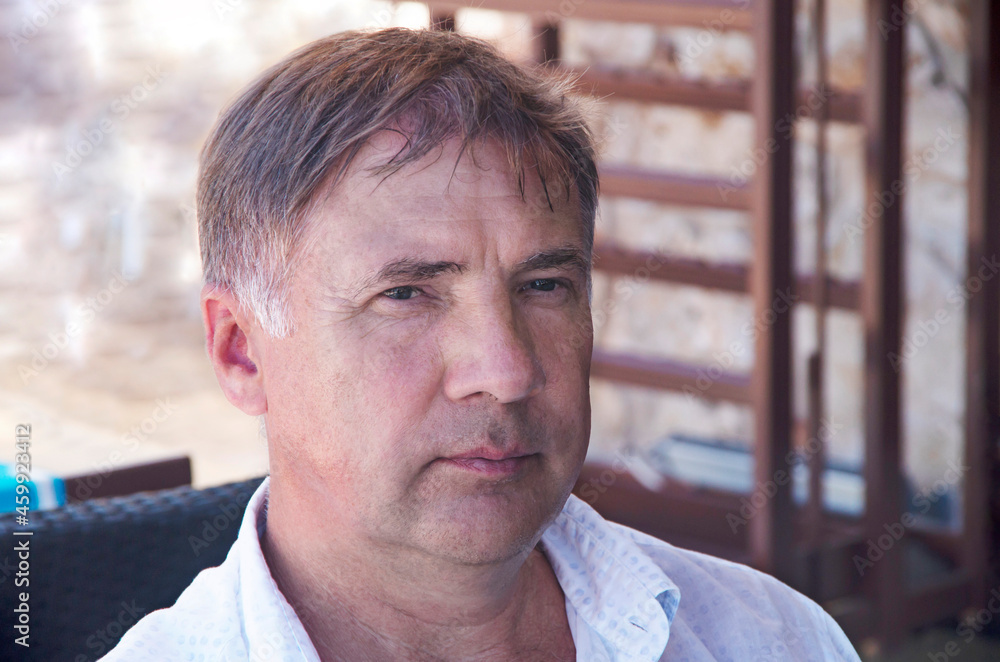 Serious face of a European man middle-aged man, over 50, close-up. Street portrait of a sad male of fifty years old, in a European city, closeup. Serious face of a European man middle-aged man, over 50, close-up. Street portrait of a sad male of fifty years old, in a European city, closeup.