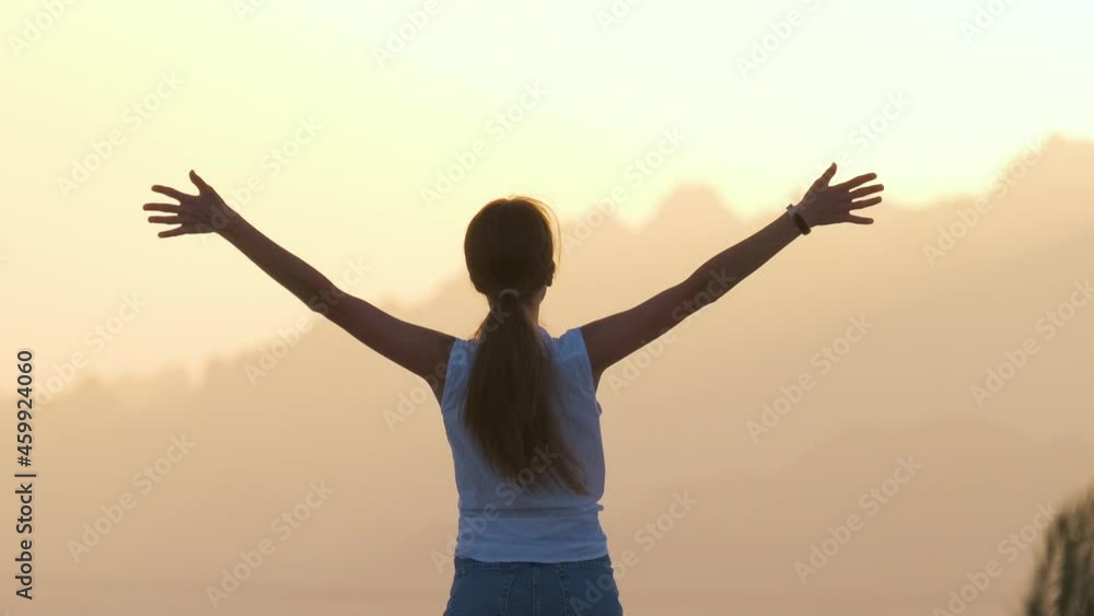 Happy woman jumping up outdoors on hotel deck on sea shore enjoying warm tropic evening. Summer vacations and travelling concept. Happy woman jumping up outdoors on hotel deck on sea shore enjoying warm tropic evening. Summer vacations and travelling concept.