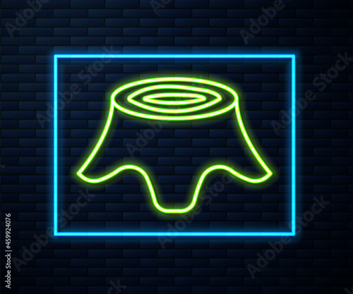 Glowing neon line Tree stump icon isolated on brick wall background. Vector