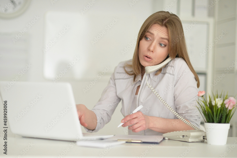 young business woman with laptop talking on phone young business woman with laptop talking on phone