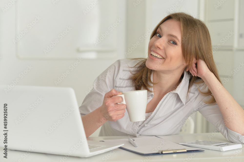young business woman with laptop drinking tea young business woman with laptop drinking tea