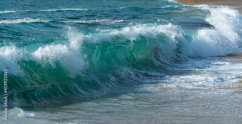 Blue waves on sandy beach 