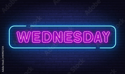 Wednesday neon sign on brick wall background.