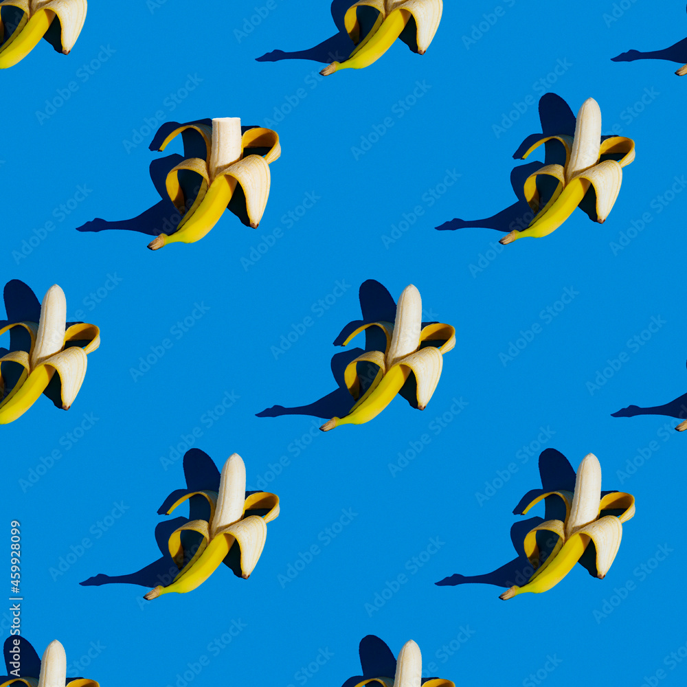 Fototapeta premium flat seamless pattern of peeled bananas on a blue background