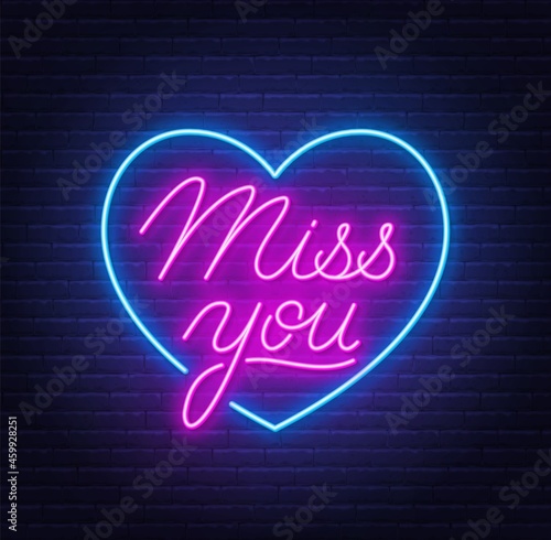 Miss You neon quote on brick wall background.