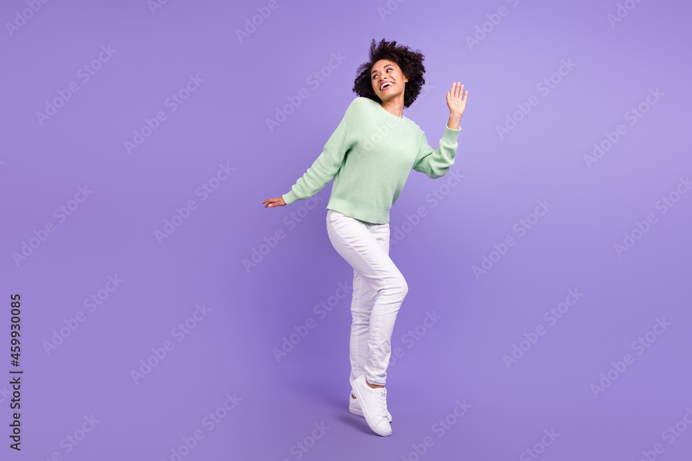 Full size photo of young dreamy dark skin happy woman look empty space isolated on violet color background