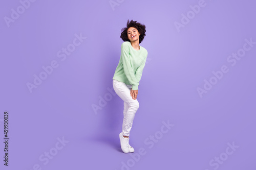 Full body photo of cheerful dark skin charming woman good mood wear casual clothes isolated on purple color background