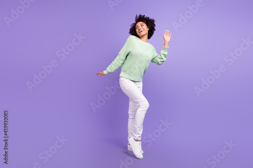 Full size photo of young dreamy dark skin happy woman look empty space isolated on violet color background © deagreez