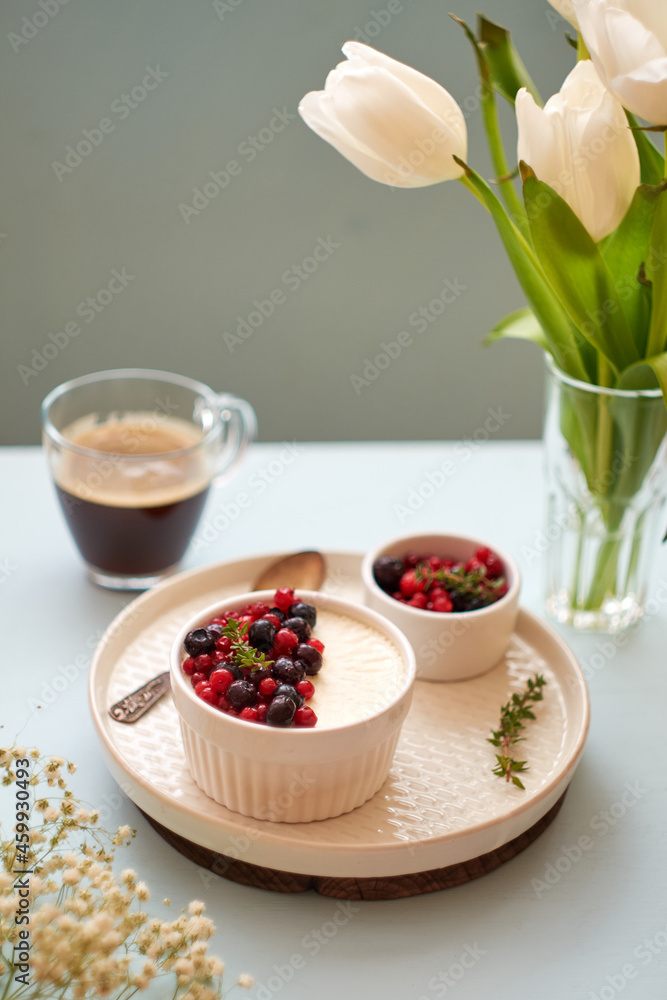 Panna cotta with berries. Blue background. Side view. Panna cotta with berries. Blue background. Side view.