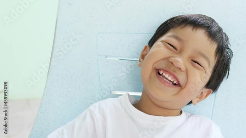 Funny asian cute child boy laughing with closeup happy relax face isolated background. Kid smiling seeing whitening teeth, having happy moment at home. Concept of freedom, fun, healthy, dental care.