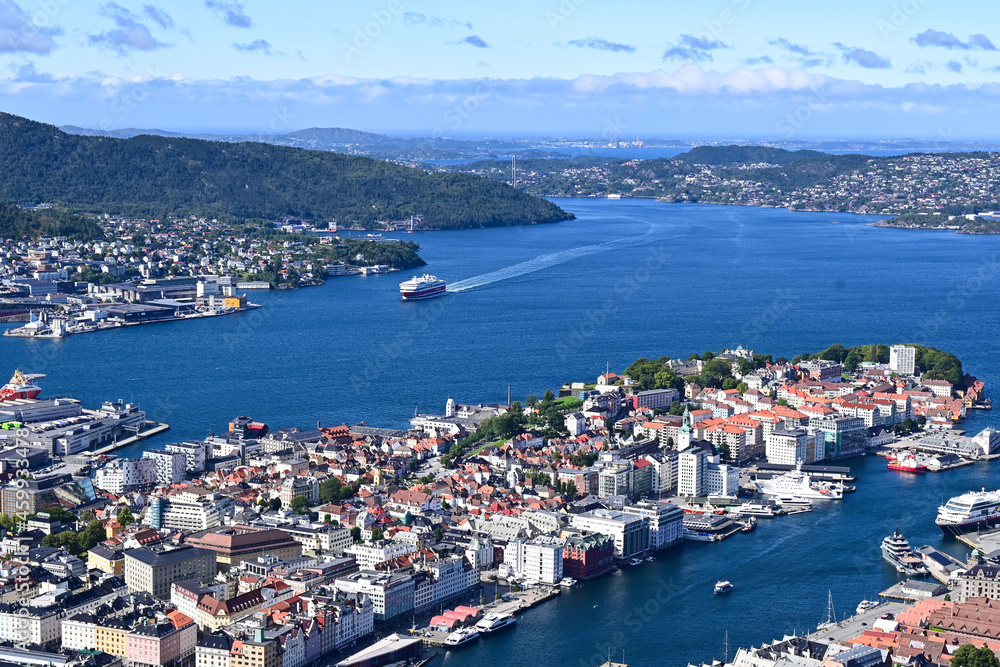 Aerial bird view of Bergen city and harbour with ferry entering the port