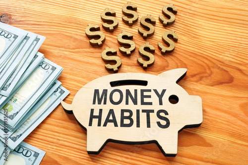 Money habits sign on the wooden piggy bank. photo