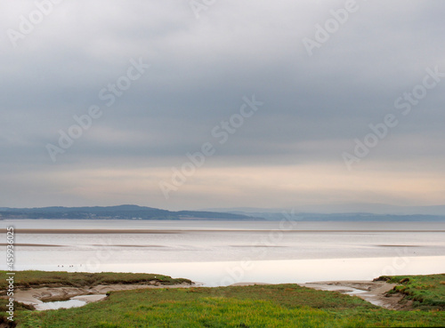 Wallpaper Mural view of the coast at grange over sands in cumbria with grass covered wetland in the foregrounds and the north lakes area in the distance Torontodigital.ca